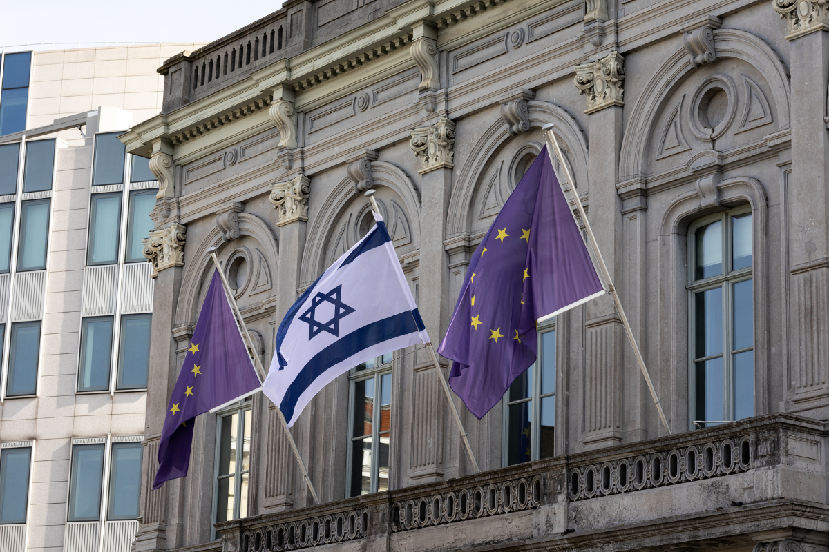 And Israeli flag sandwiched between two flags of the European Union on a building